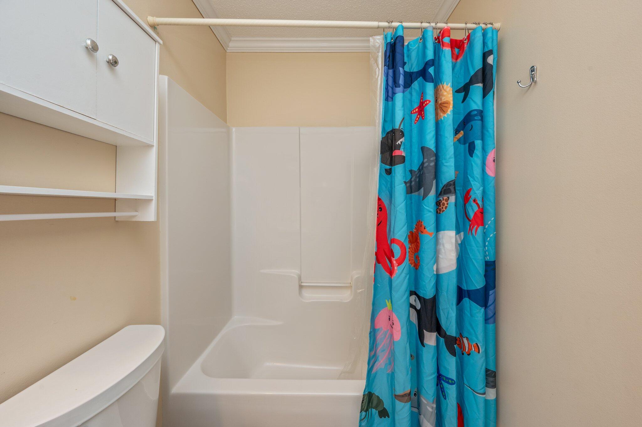 695 Randall Roberts Road Fort Walton Beach, FL 32547 - Photo 32 of 40 a bathroom with a bathtub and a shower curtain
