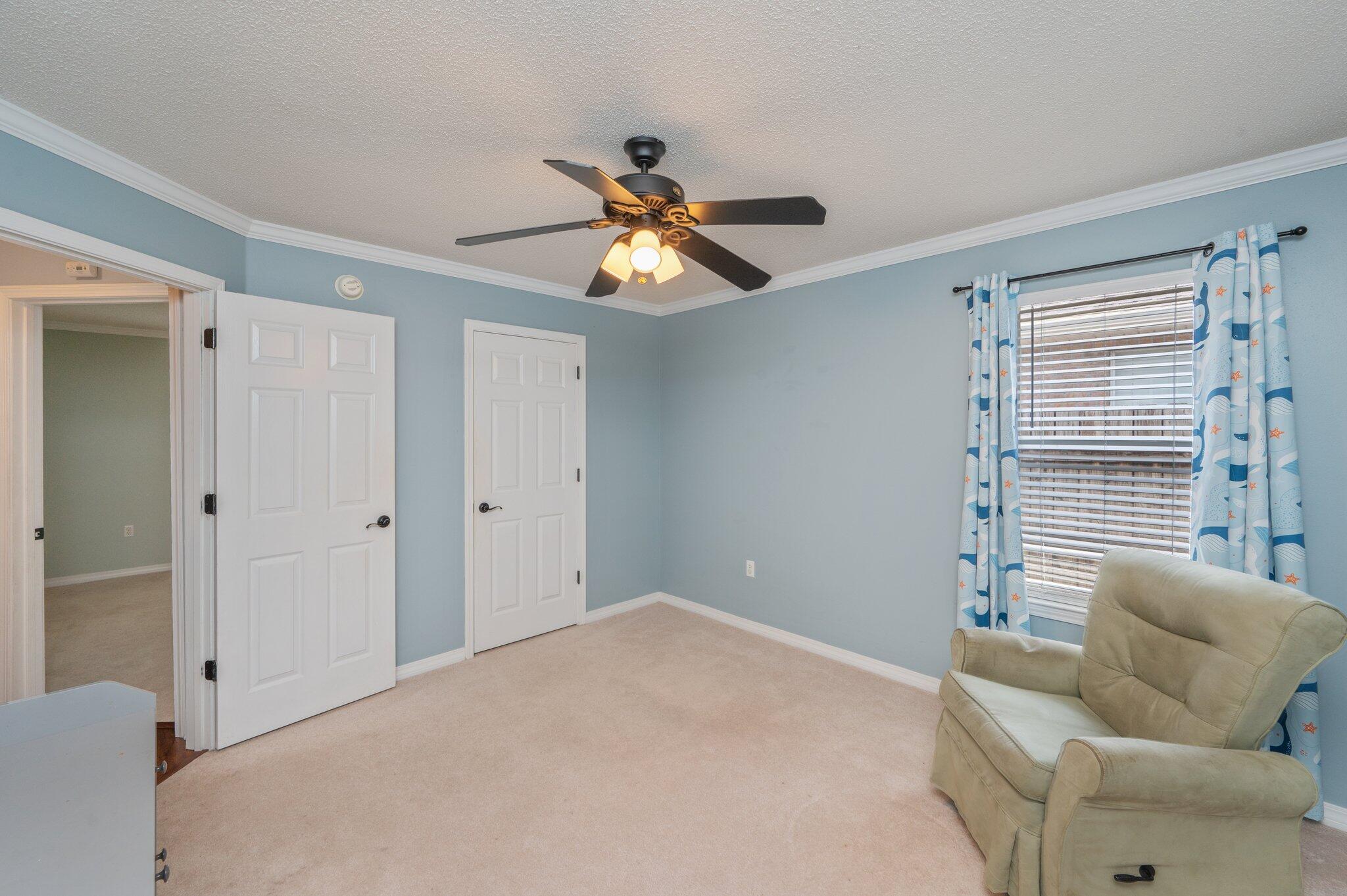 695 Randall Roberts Road Fort Walton Beach, FL 32547 - Photo 33 of 40 a bedroom with a bed and a chandelier