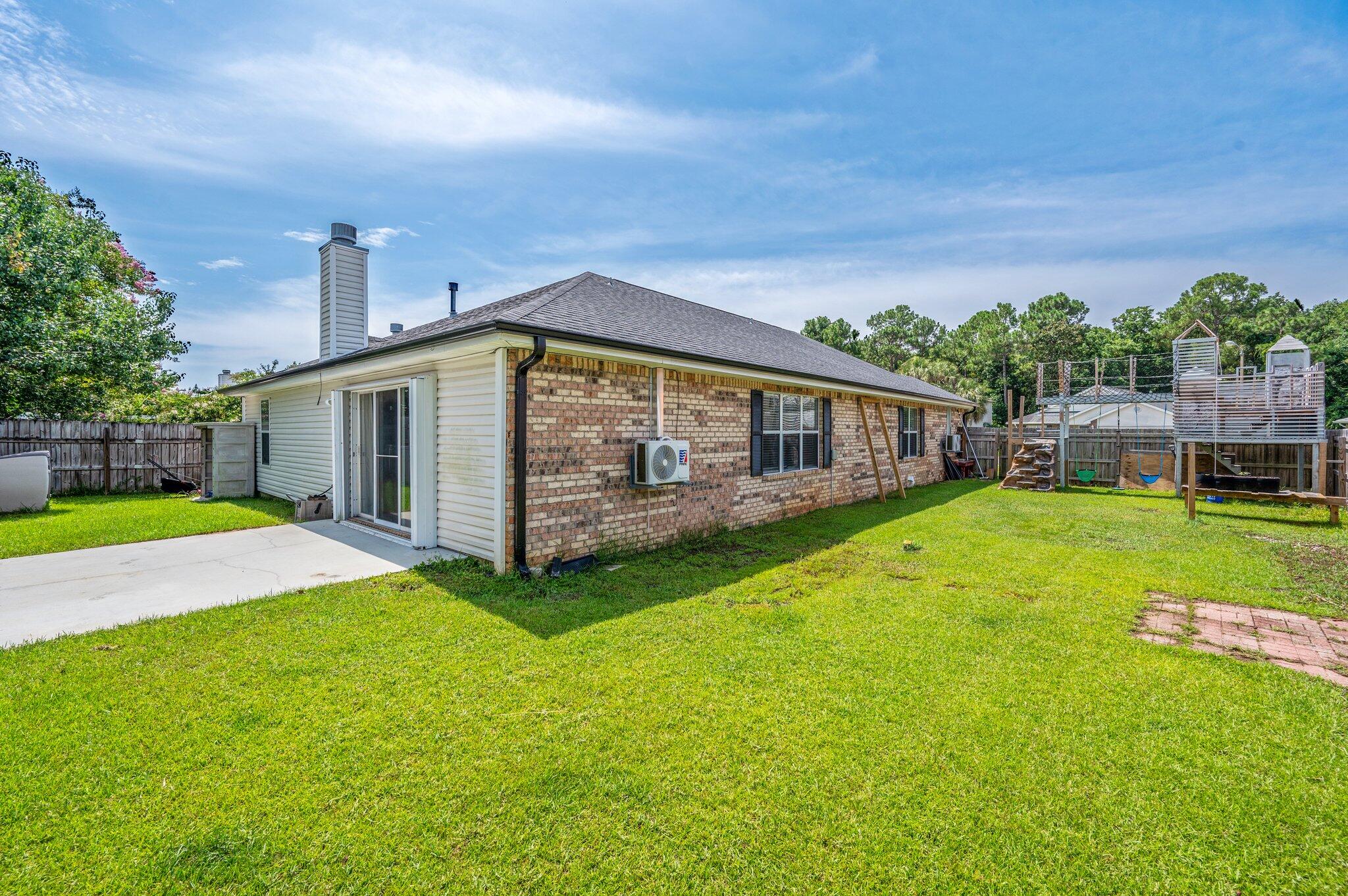 695 Randall Roberts Road Fort Walton Beach, FL 32547 - Photo 37 of 40 a view of a house with a backyard and a patio