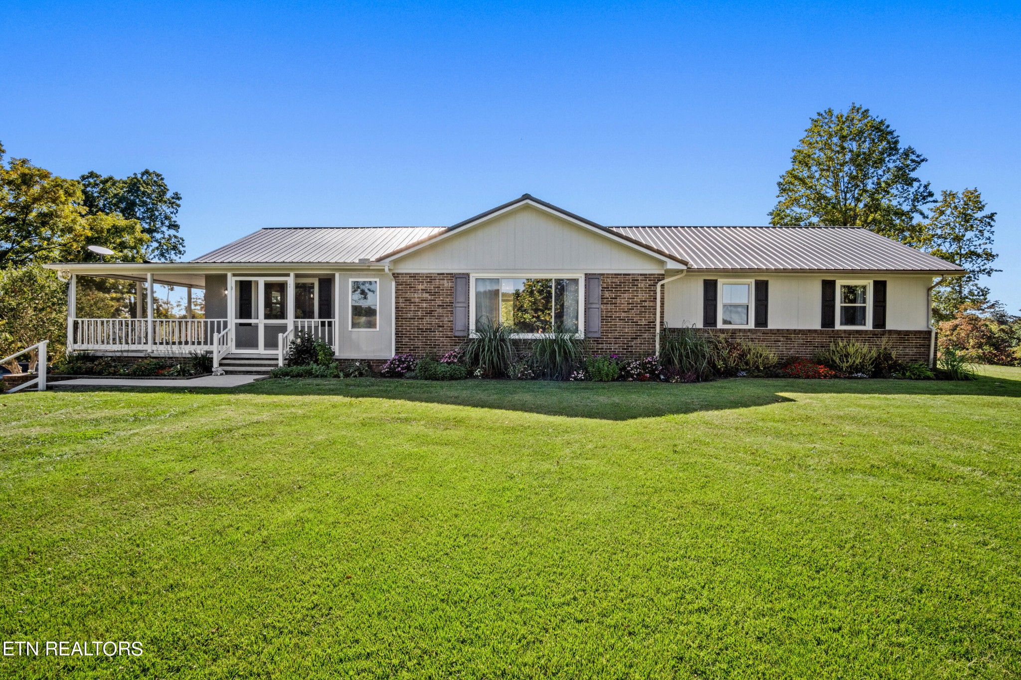 3674 Pleasant Ridge Road Talbott, TN 37877 - Photo 2 of 60 a front view of a house with a garden and trees