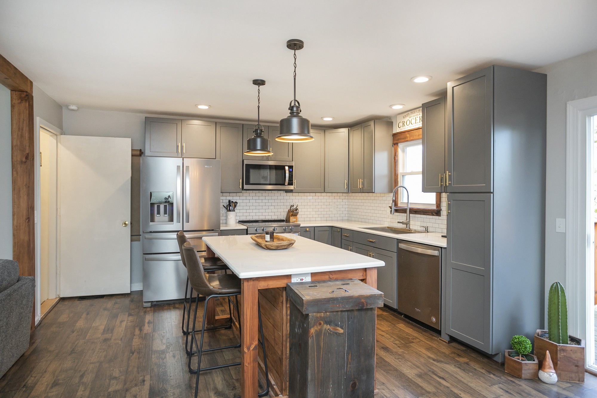 1124 Jacksons View Road Hermitage, TN 37076 - Photo 8 of 22 a kitchen with kitchen island white cabinets appliances and wooden floor