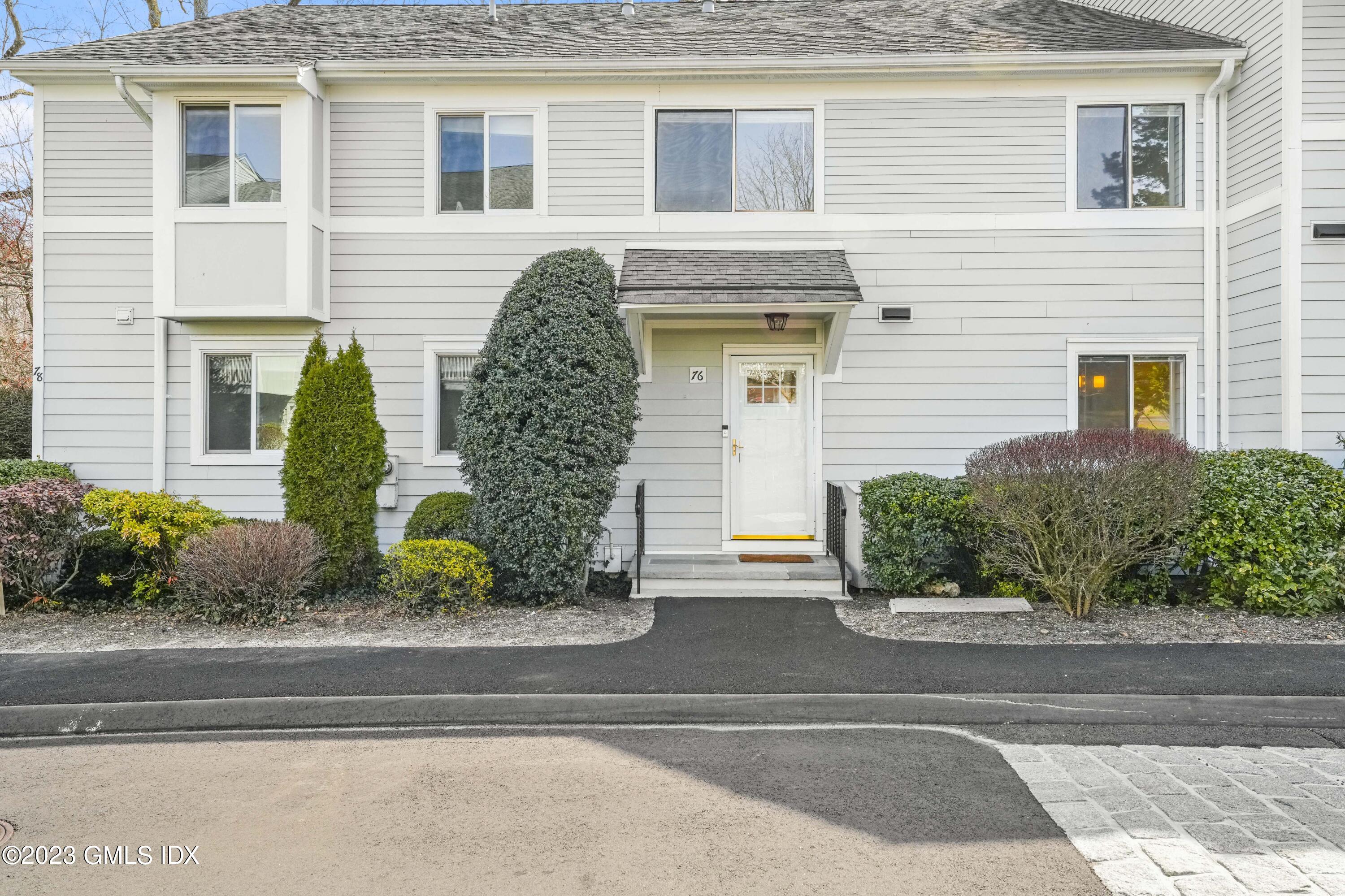 76 Silo Circle, Unit 76 Riverside, CT 06878 - Photo 2 of 40 a front view of a house with garden