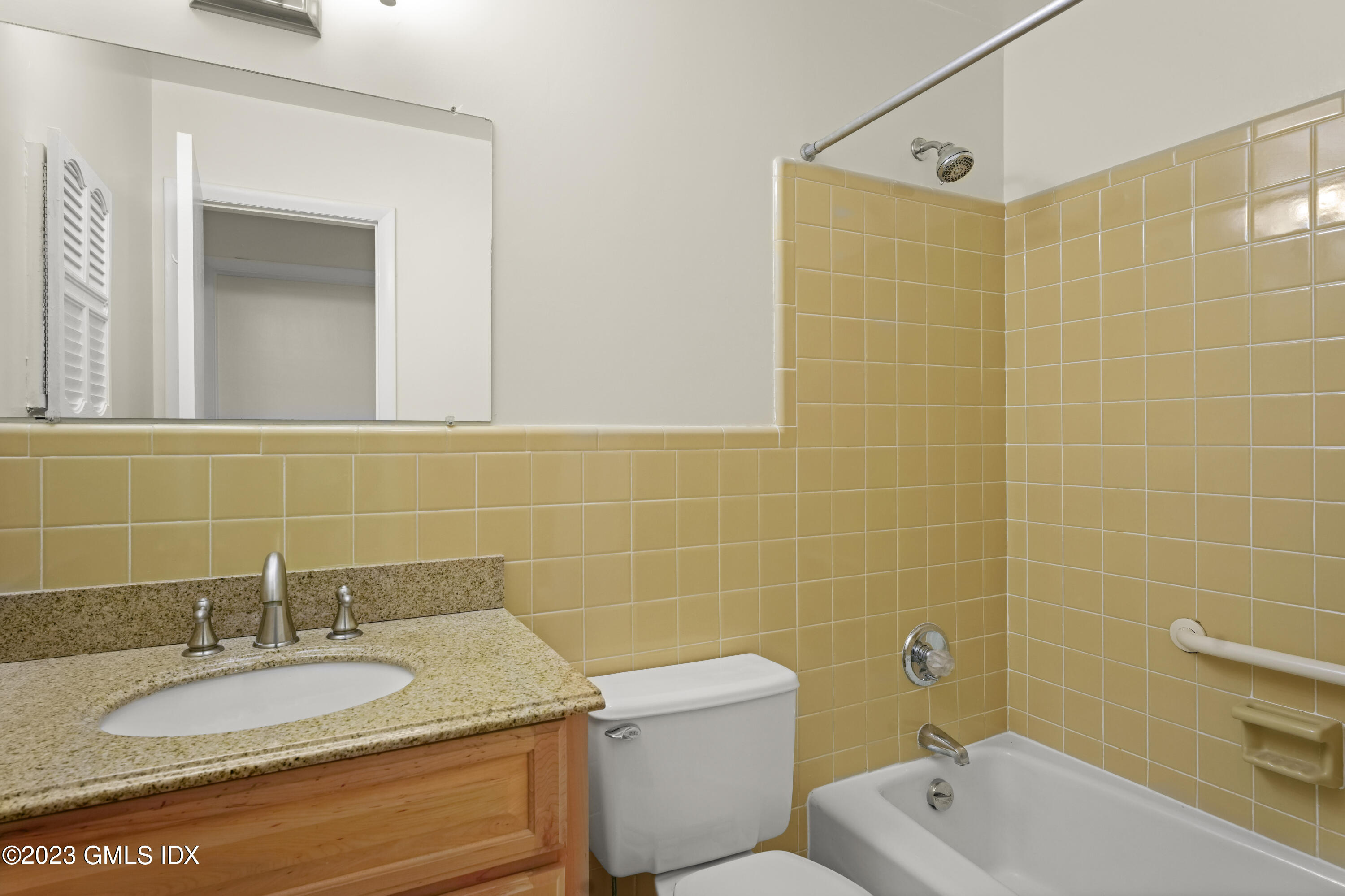 76 Silo Circle, Unit 76 Riverside, CT 06878 - Photo 27 of 40 a bathroom with a granite countertop sink and a large mirror