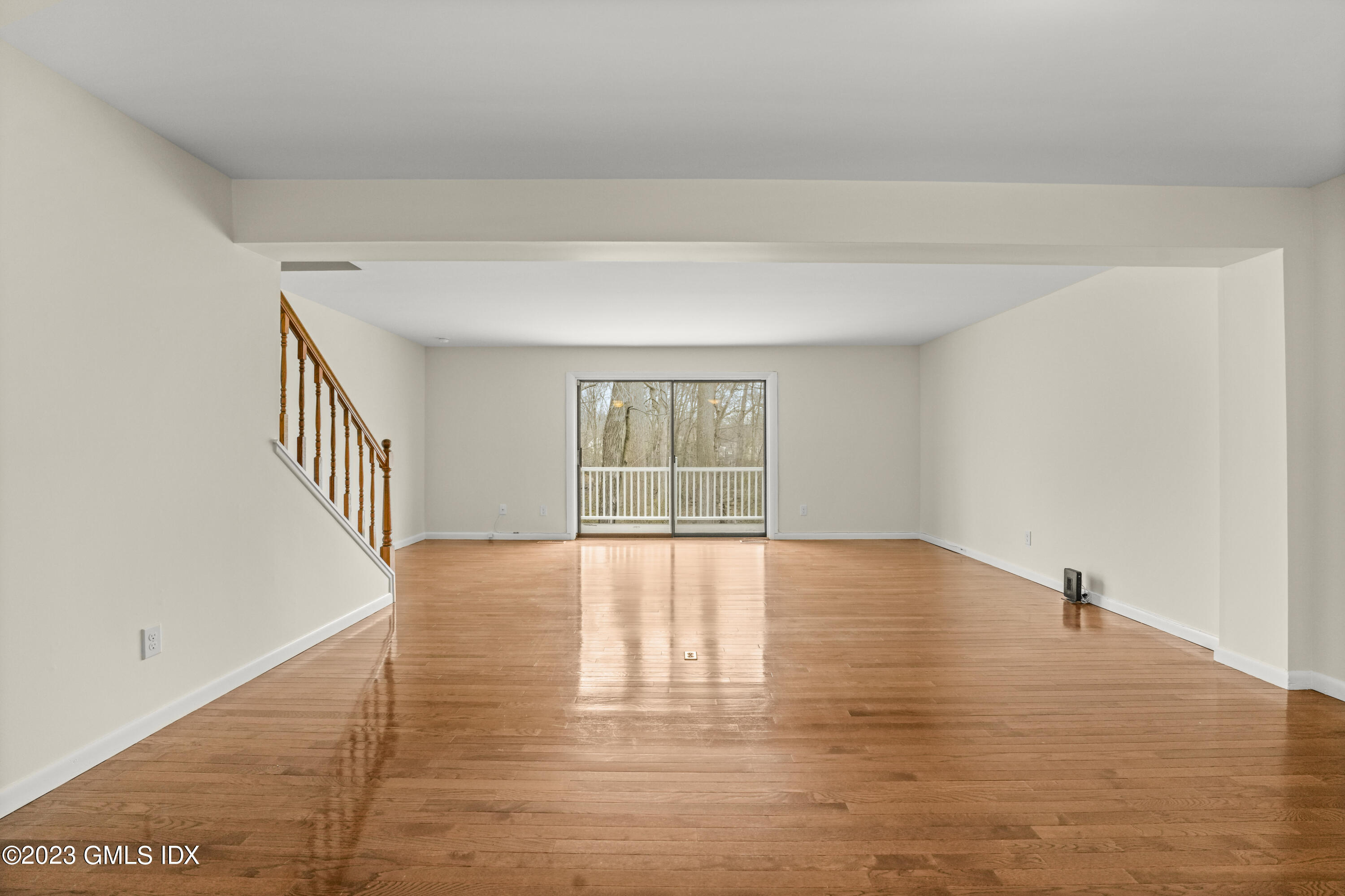 76 Silo Circle, Unit 76 Riverside, CT 06878 - Photo 3 of 40 a view of an empty room with wooden floor and a window