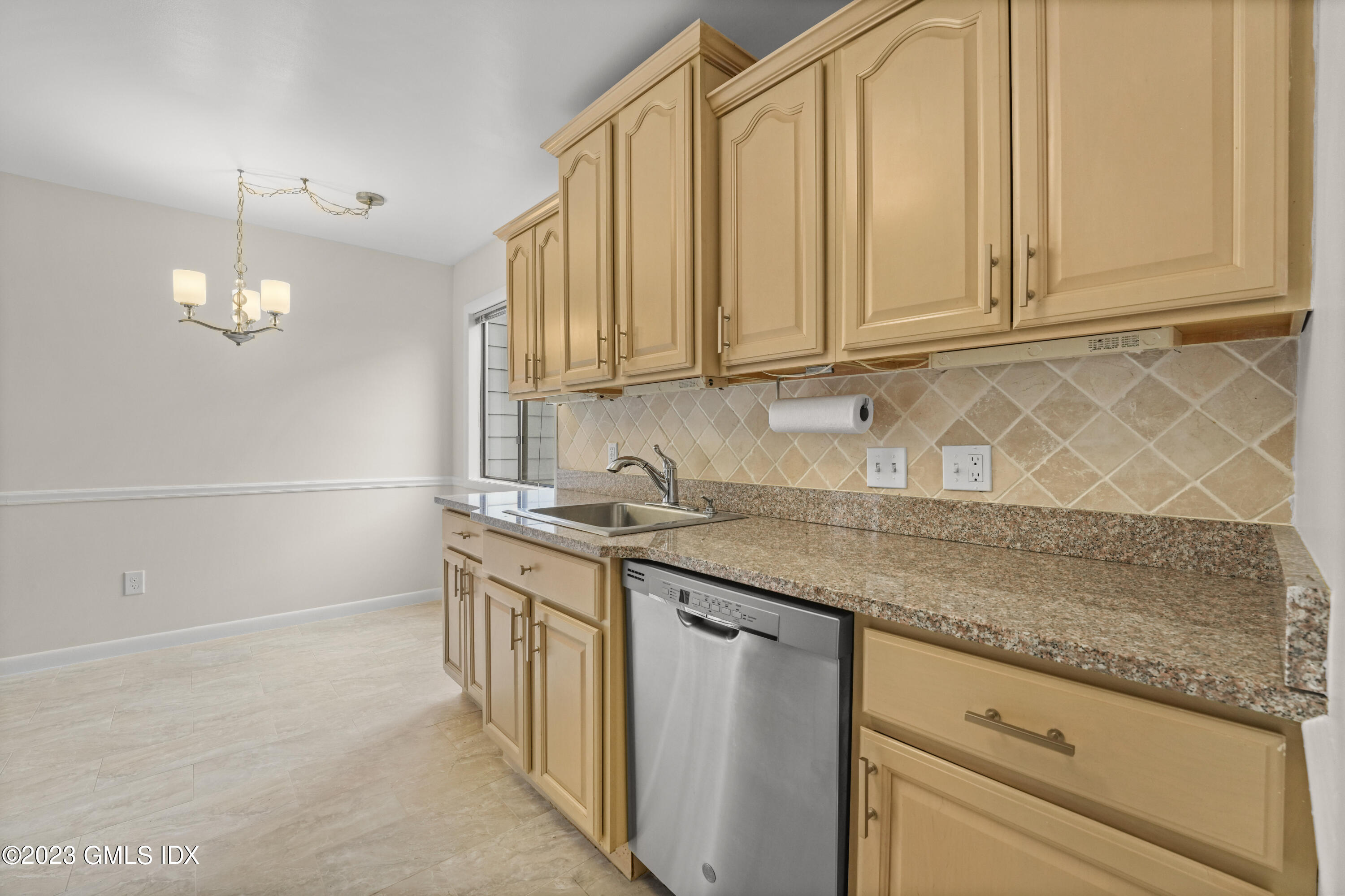 76 Silo Circle, Unit 76 Riverside, CT 06878 - Photo 7 of 40 a kitchen with granite countertop a sink and a stove