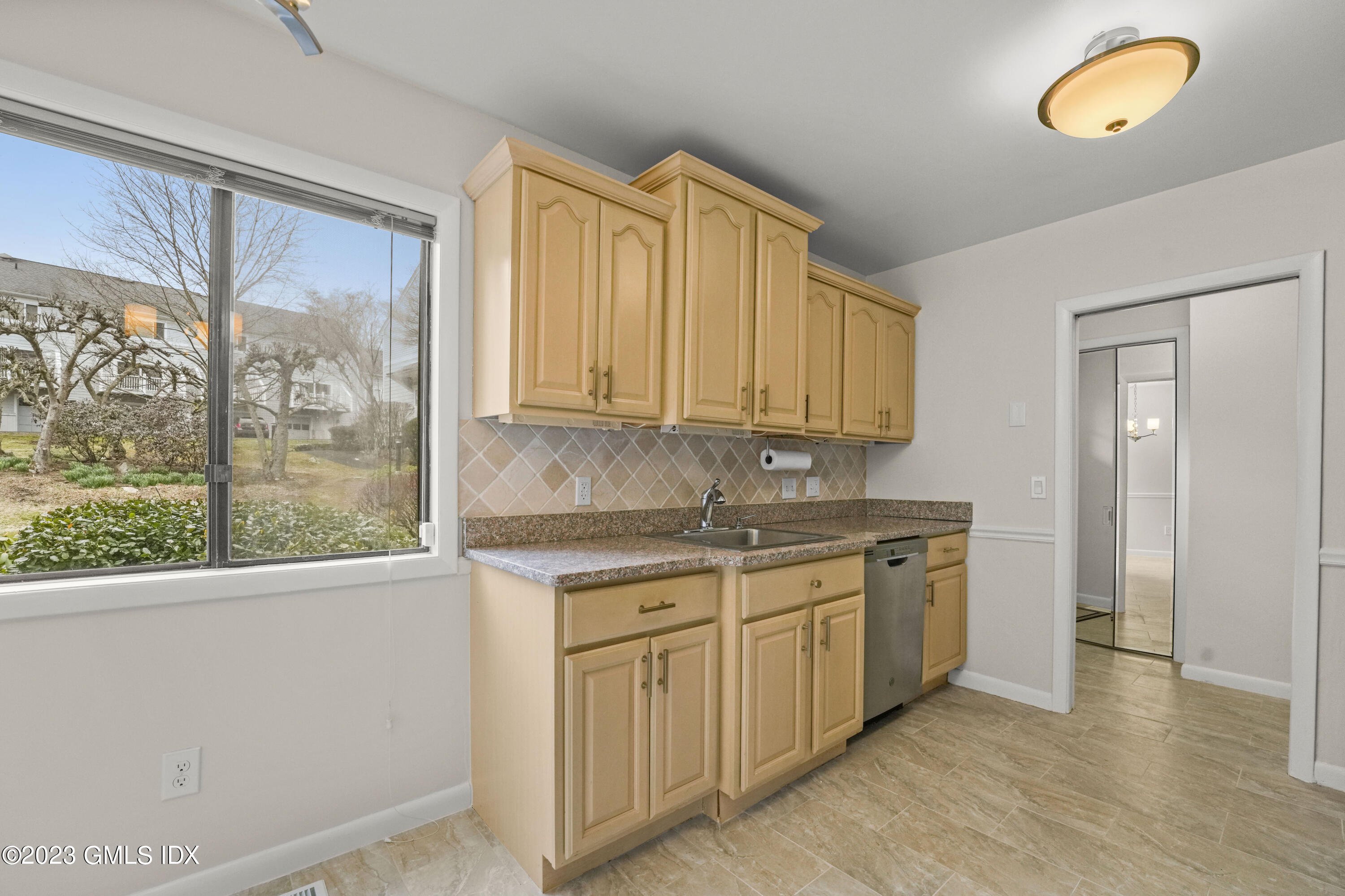 76 Silo Circle, Unit 76 Riverside, CT 06878 - Photo 8 of 40 a kitchen with stainless steel appliances granite countertop a stove a sink and a refrigerator with wooden floor