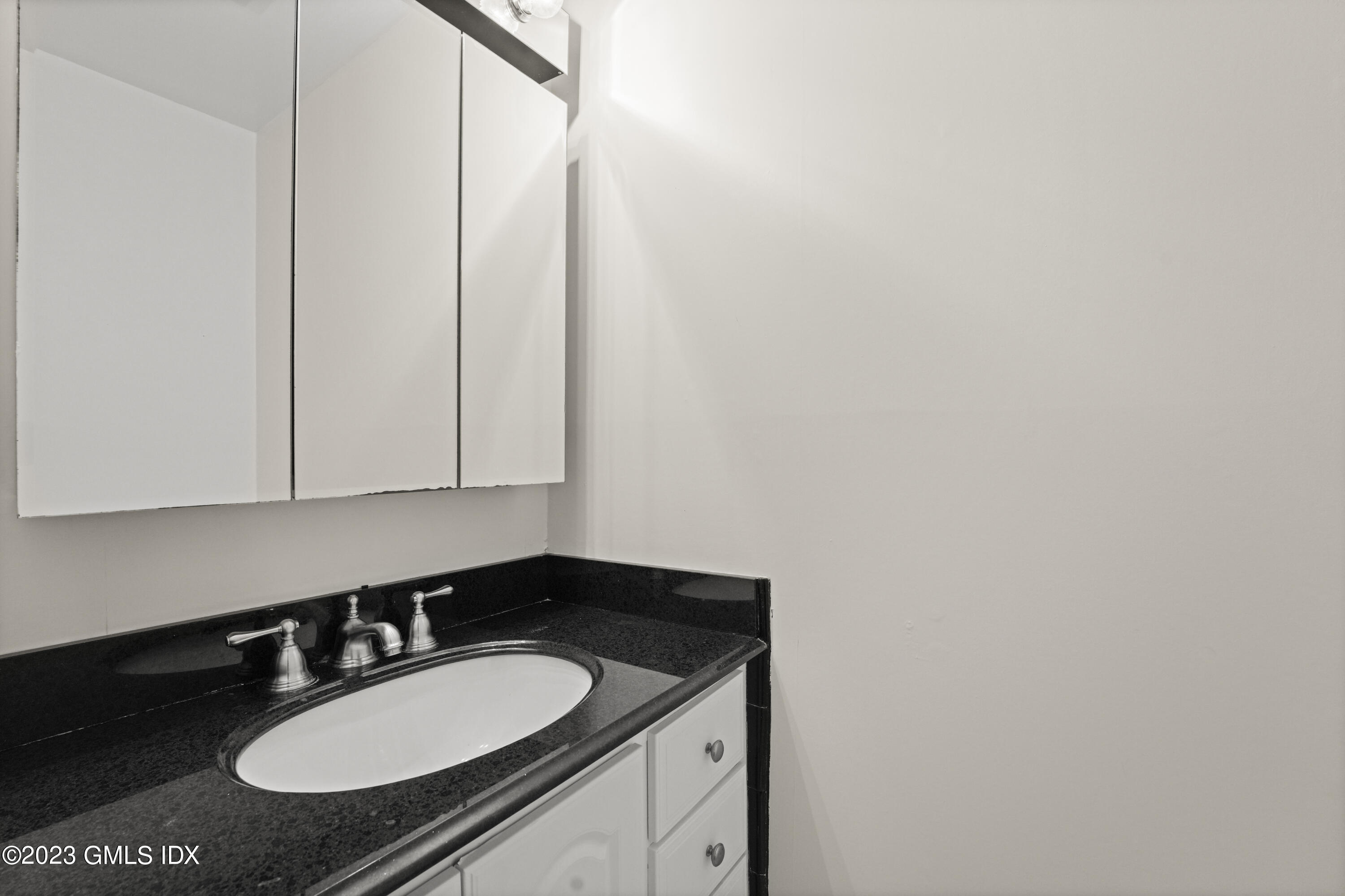 76 Silo Circle, Unit 76 Riverside, CT 06878 - Photo 10 of 40 a bathroom with a granite countertop sink and a mirror