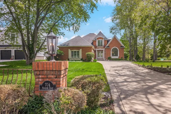 a front view of a house with a garden and yard