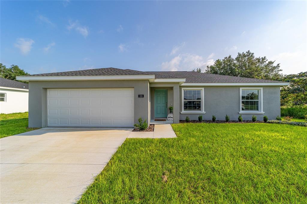 4489 Southwest 172nd Pl Road Ocala, FL 34473 - Photo 1 of 1 a front view of house with yard and green space