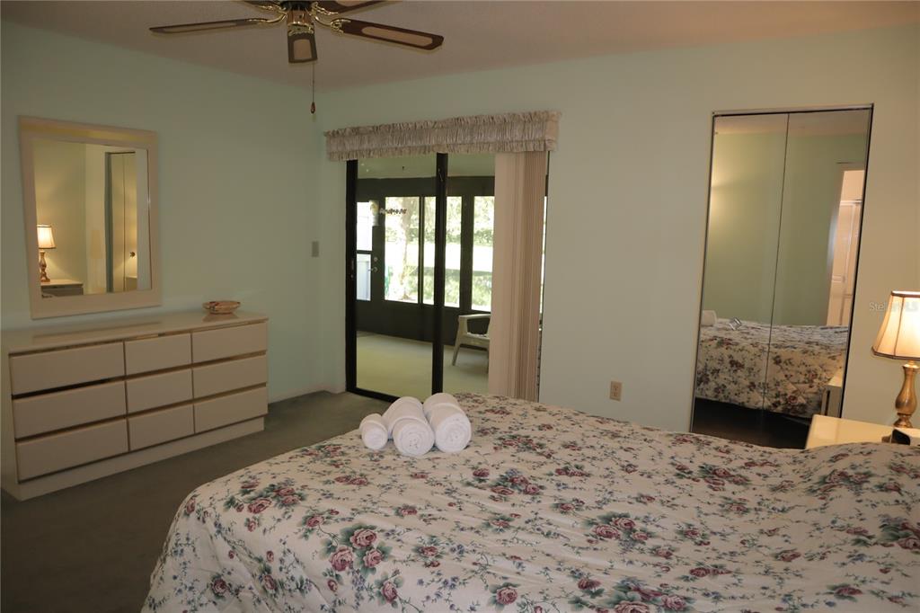 1389 Pine Ridge Circle East, Unit D8 Tarpon Springs, FL 34688 - Photo 11 of 30 a bedroom with a bed and a window