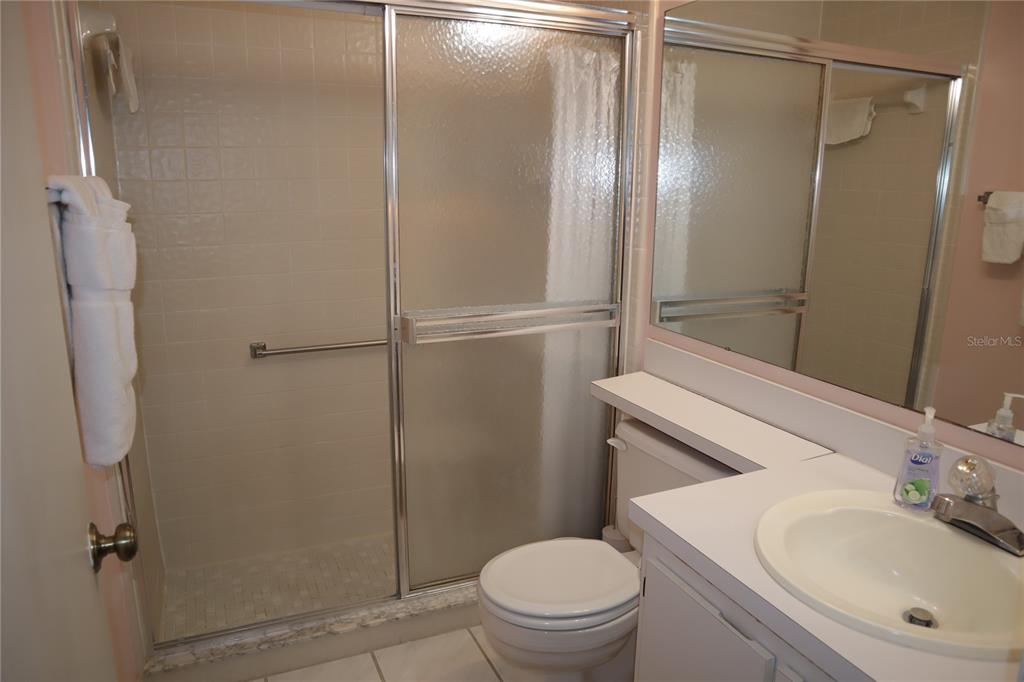 1389 Pine Ridge Circle East, Unit D8 Tarpon Springs, FL 34688 - Photo 12 of 30 a bathroom with a sink toilet and shower