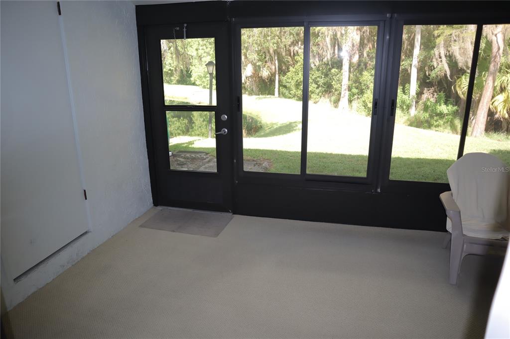 1389 Pine Ridge Circle East, Unit D8 Tarpon Springs, FL 34688 - Photo 16 of 30 a living room with a large window