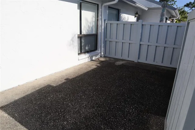 a view of backyard with wooden fence