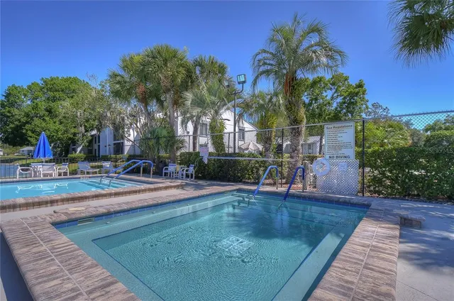 front view of house with a yard and potted plants