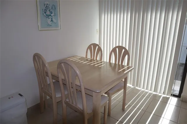 a view of a dining room with furniture and window