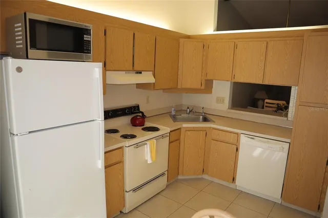 a kitchen with a refrigerator sink and microwave