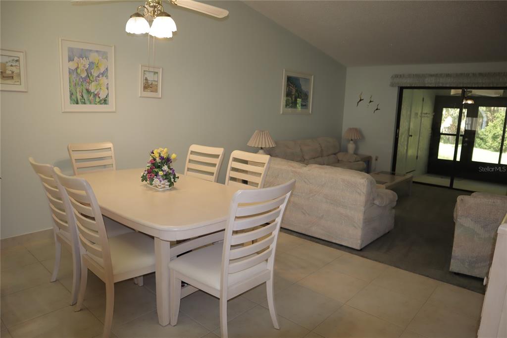 1389 Pine Ridge Circle East, Unit D8 Tarpon Springs, FL 34688 - Photo 7 of 30 a dining room with furniture and window