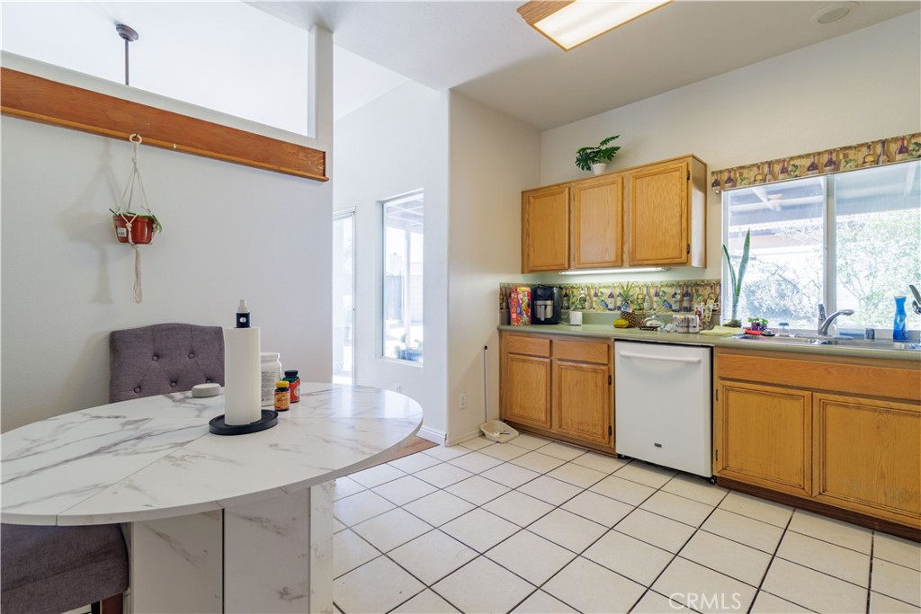 1393 Rabbit Peak Way Hemet, CA 92545 - Photo 13 of 34 a kitchen with a sink cabinets and window