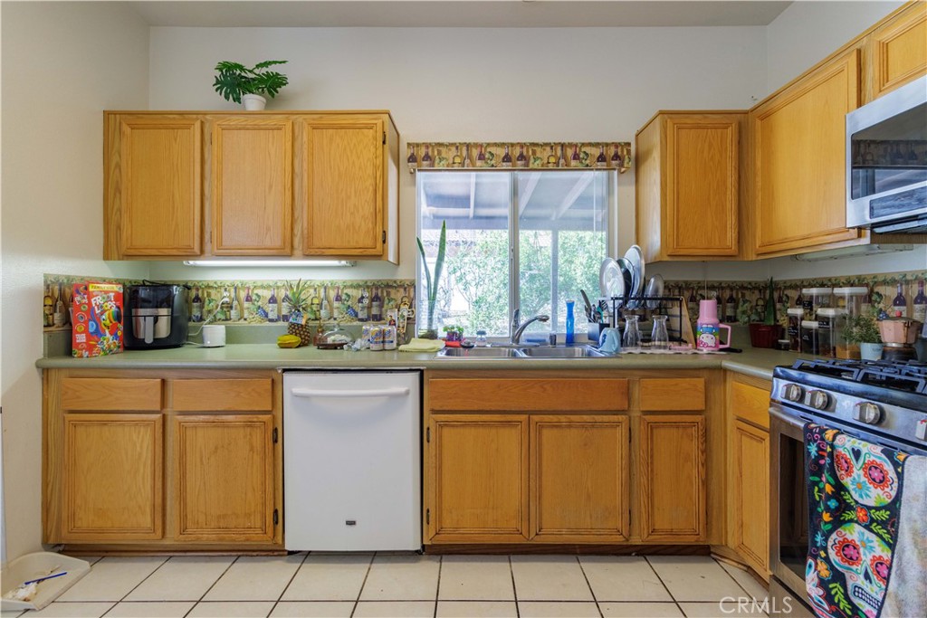 1393 Rabbit Peak Way Hemet, CA 92545 - Photo 14 of 34 a kitchen with cabinets appliances and a window