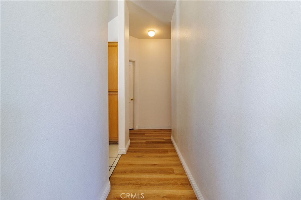 1393 Rabbit Peak Way Hemet, CA 92545 - Photo 17 of 34 a view of a hallway with wooden floor