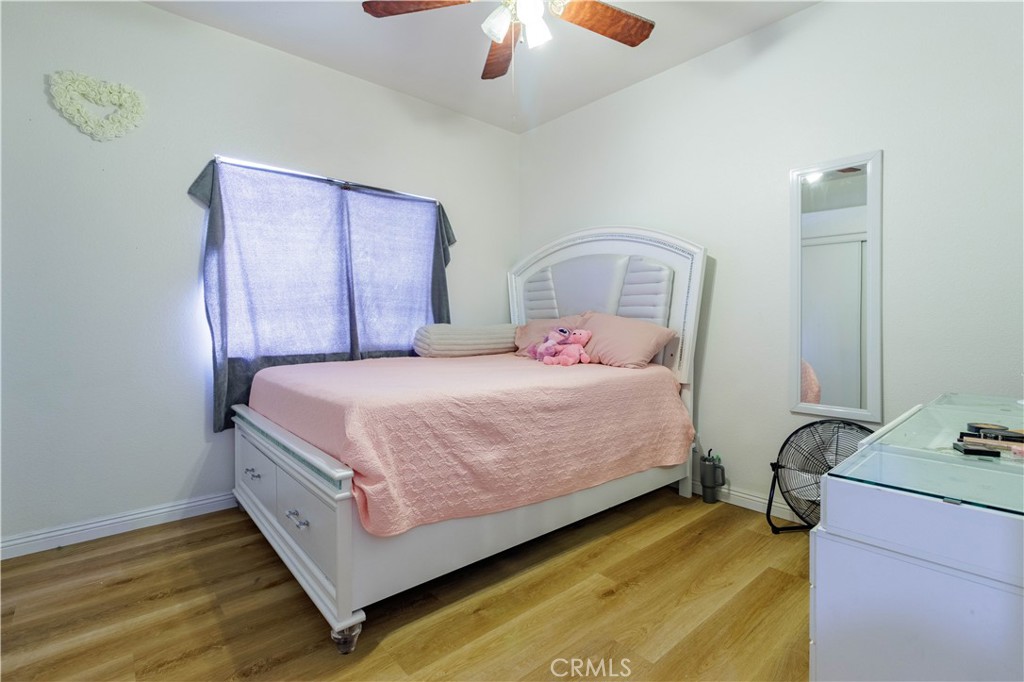 1393 Rabbit Peak Way Hemet, CA 92545 - Photo 21 of 34 a bedroom with a bed and a chandelier