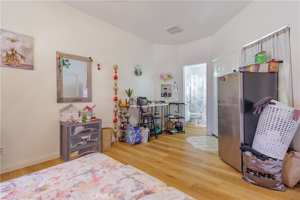 1393 Rabbit Peak Way Hemet, CA 92545 - Photo 25 of 34 a bed room with a bed a desk and a painting