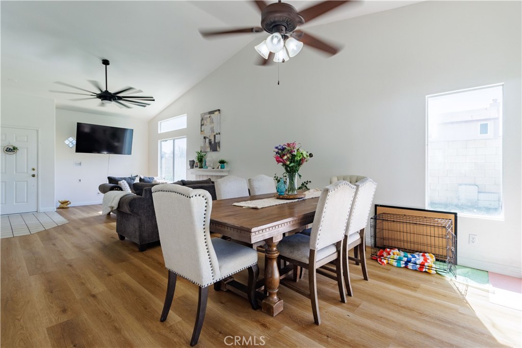 1393 Rabbit Peak Way Hemet, CA 92545 - Photo 9 of 34 a dining room with furniture a chandelier and wooden floor