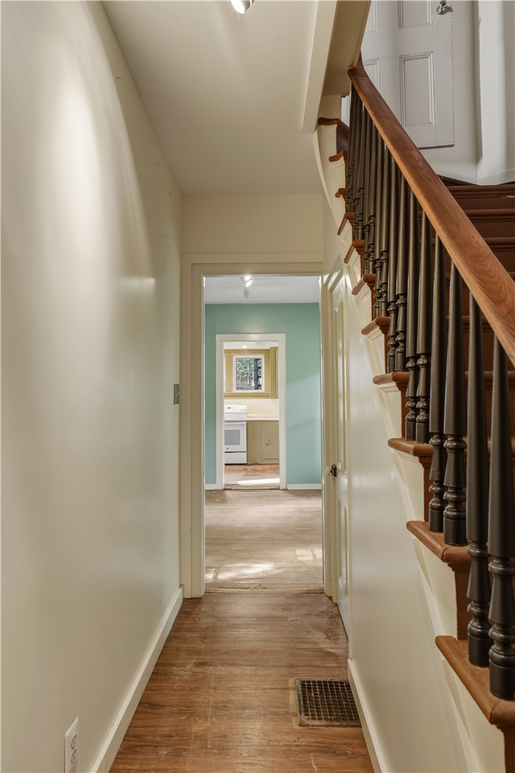 5 Powderhouse Road Corning, NY 14830 - Photo 13 of 47 A classic wooden staircase borders a long hallway