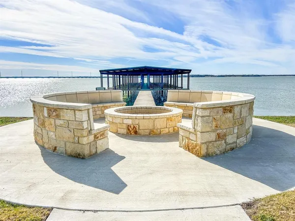 a view of a playground with swimming pool and green space