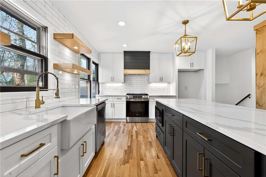 671 Willow Ridge Drive Northeast Marietta, GA 30068 - Photo 11 of 36 a large kitchen with stainless steel appliances granite countertop a stove and a sink