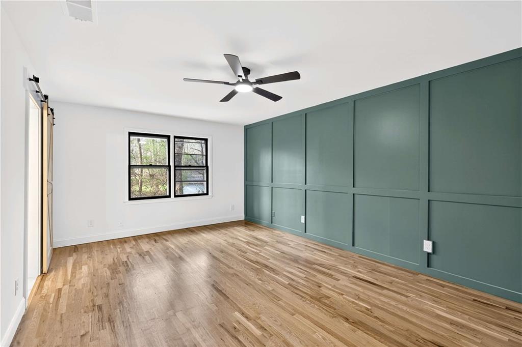 671 Willow Ridge Drive Northeast Marietta, GA 30068 - Photo 12 of 36 a view of empty room with windows and ceiling fan