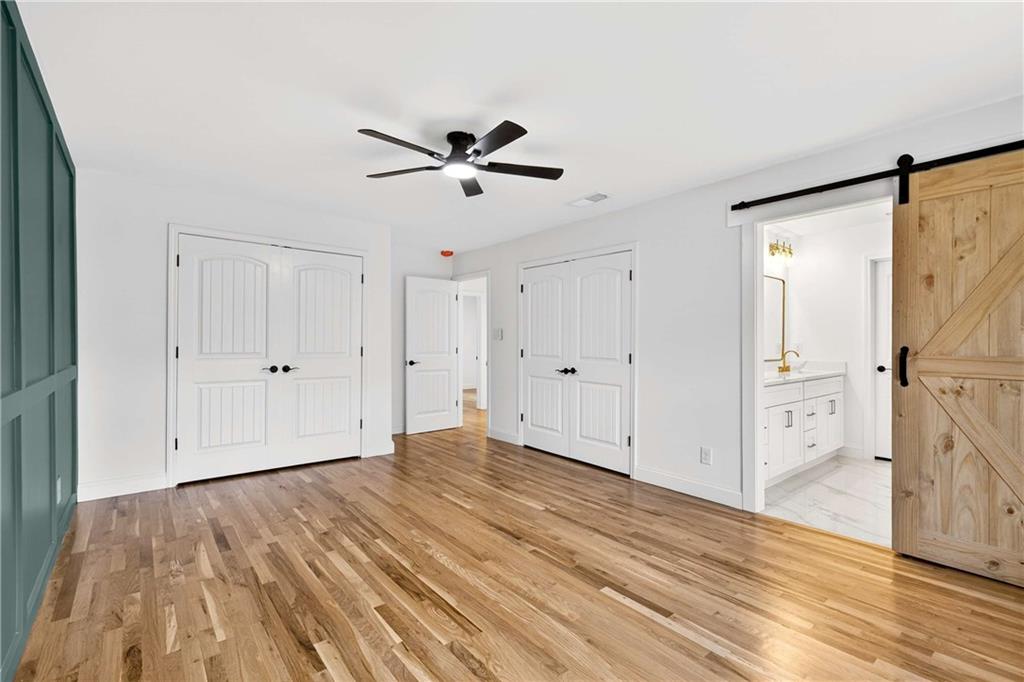 671 Willow Ridge Drive Northeast Marietta, GA 30068 - Photo 13 of 36 a view of empty room with wooden floor and fan