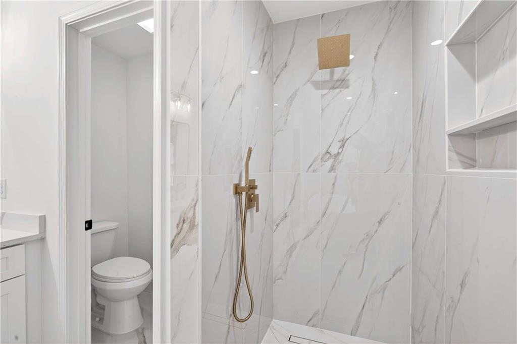 671 Willow Ridge Drive Northeast Marietta, GA 30068 - Photo 15 of 36 a bathroom with a granite countertop shower and a toilet