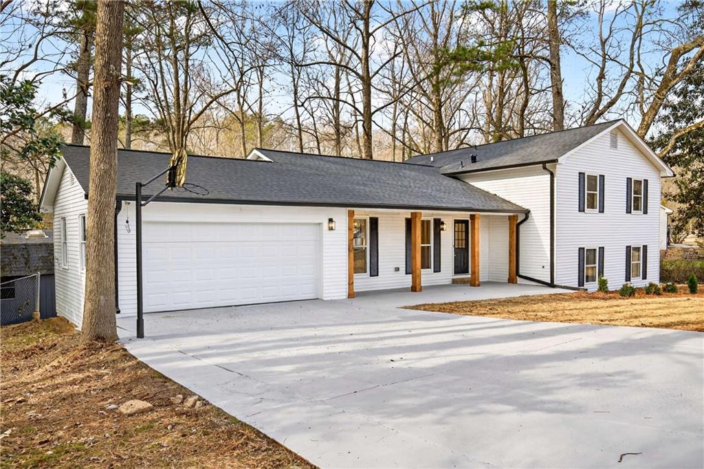 671 Willow Ridge Drive Northeast Marietta, GA 30068 - Photo 2 of 36 a front view of a house with a yard and garage