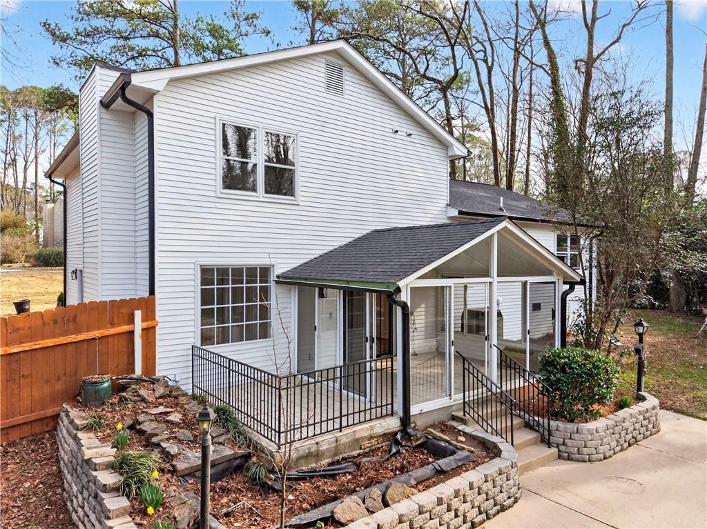 671 Willow Ridge Drive Northeast Marietta, GA 30068 - Photo 29 of 36 a white house with large trees and wooden fence