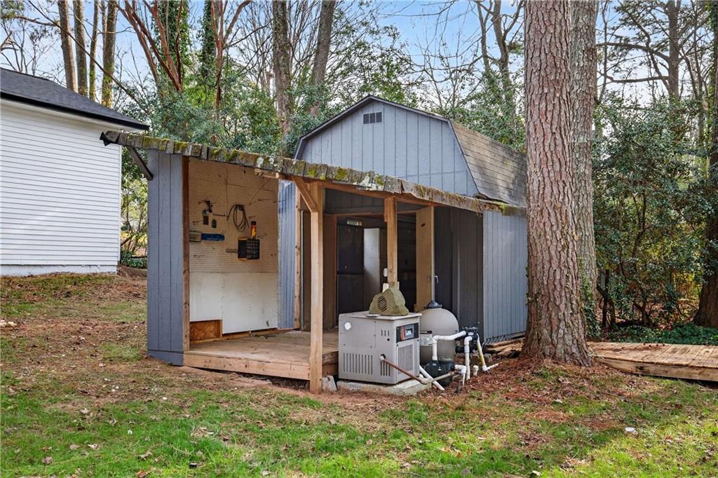 671 Willow Ridge Drive Northeast Marietta, GA 30068 - Photo 32 of 36 a view of a backyard with a small cabin and a chair