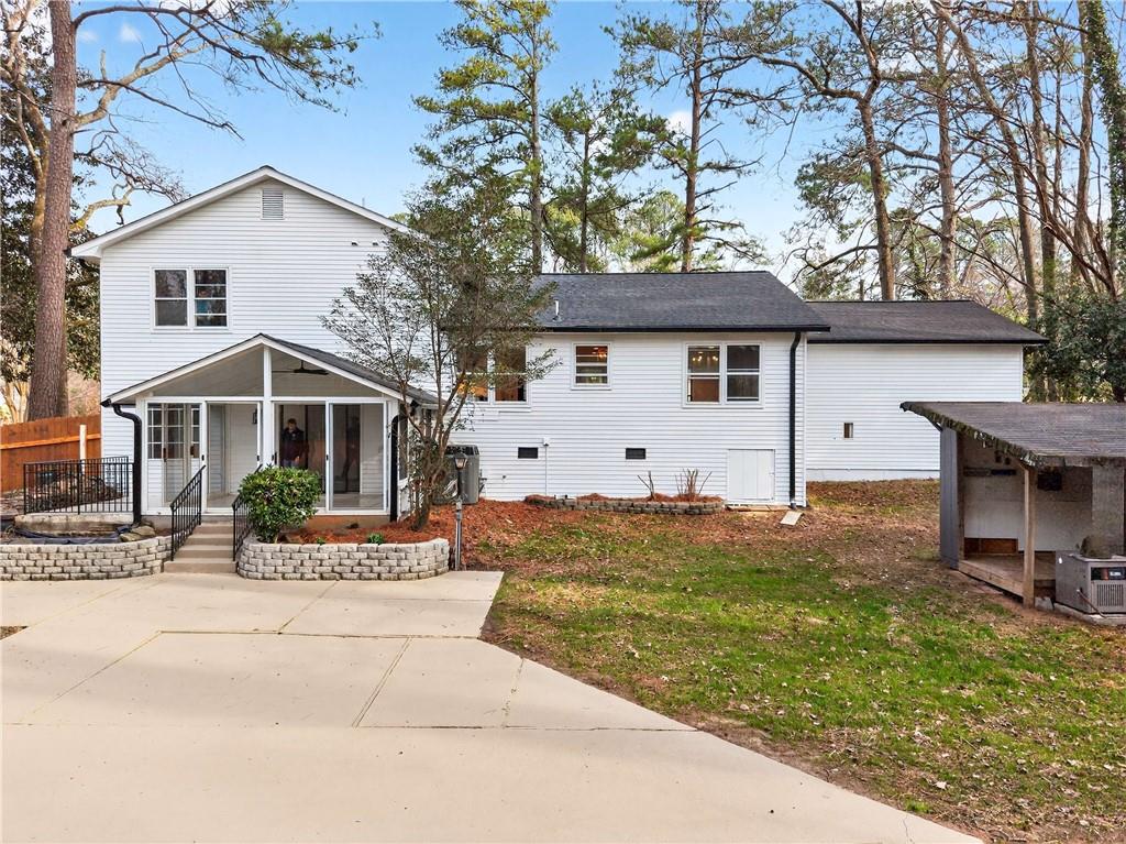 671 Willow Ridge Drive Northeast Marietta, GA 30068 - Photo 33 of 36 a front view of house with yard and trees in the background