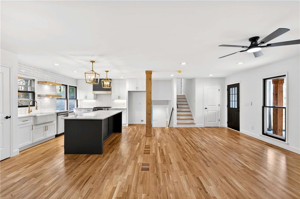 671 Willow Ridge Drive Northeast Marietta, GA 30068 - Photo 8 of 36 a large kitchen with kitchen island a sink dishwasher a stove and a refrigerator with wooden floor