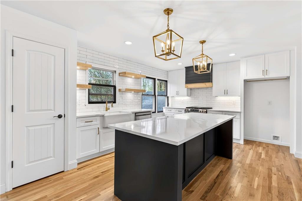 671 Willow Ridge Drive Northeast Marietta, GA 30068 - Photo 9 of 36 a kitchen with a sink and wooden floor