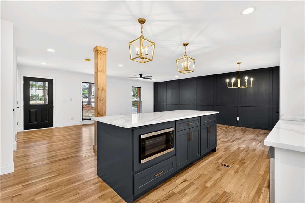 671 Willow Ridge Drive Northeast Marietta, GA 30068 - Photo 10 of 36 a kitchen with stainless steel appliances granite countertop a sink a stove and a wooden floors