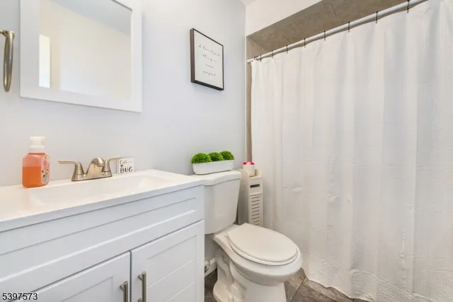 a bathroom with a sink a toilet and a mirror