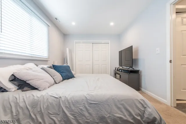 a bedroom with a bed and a television