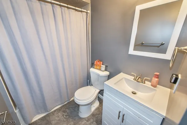 a white toilet sitting next to a bathroom sink