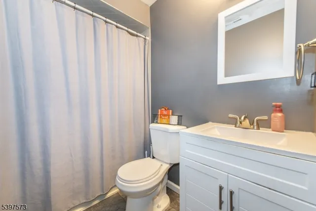 a bathroom with a sink a toilet and a mirror