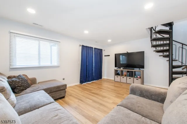 a bedroom with a bed a television and a couch