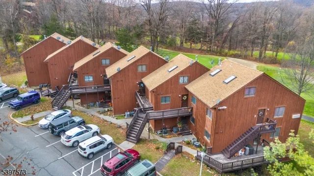 a view of a house with a chairs and table in a patio