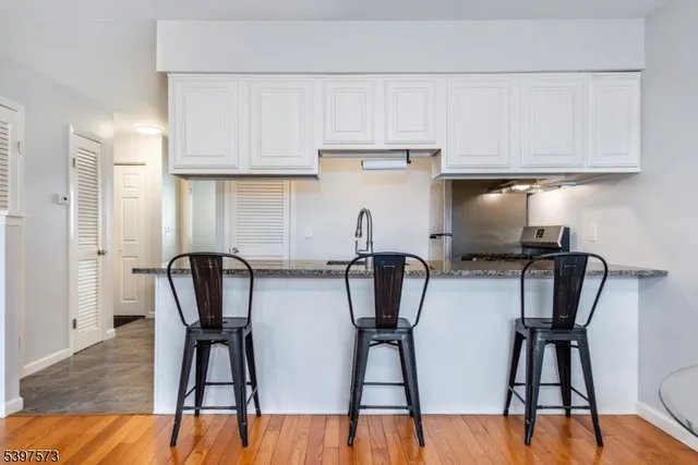 a view of kitchen with cabinets and wooden floor