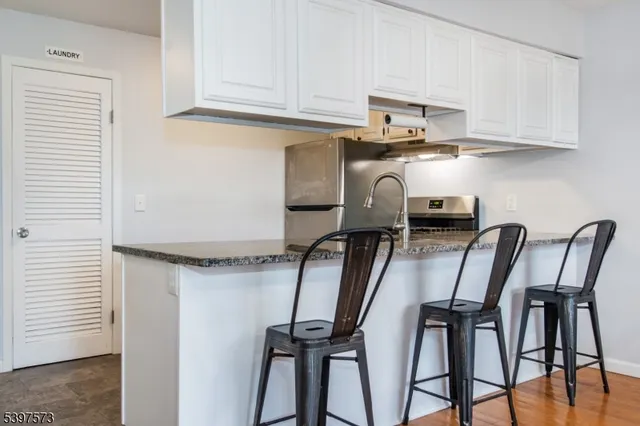 a view of kitchen with furniture and wooden floor