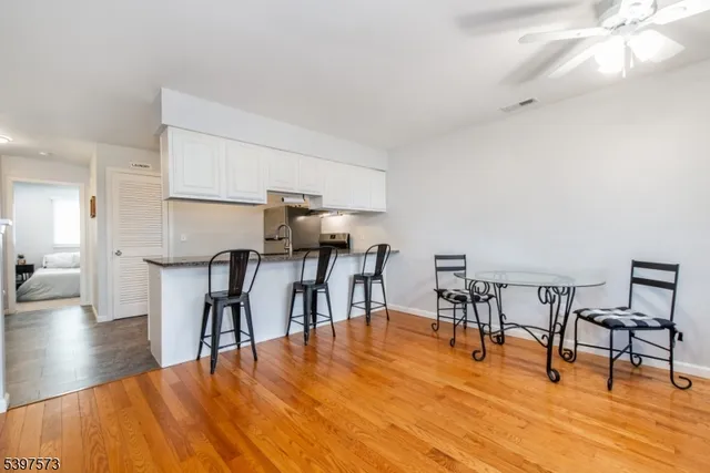 a view of a dining room with furniture and wooden floor