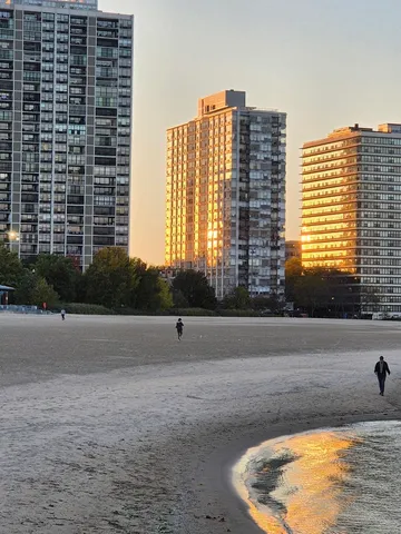 a kitchen with granite countertop a stove a sink and wooden floors